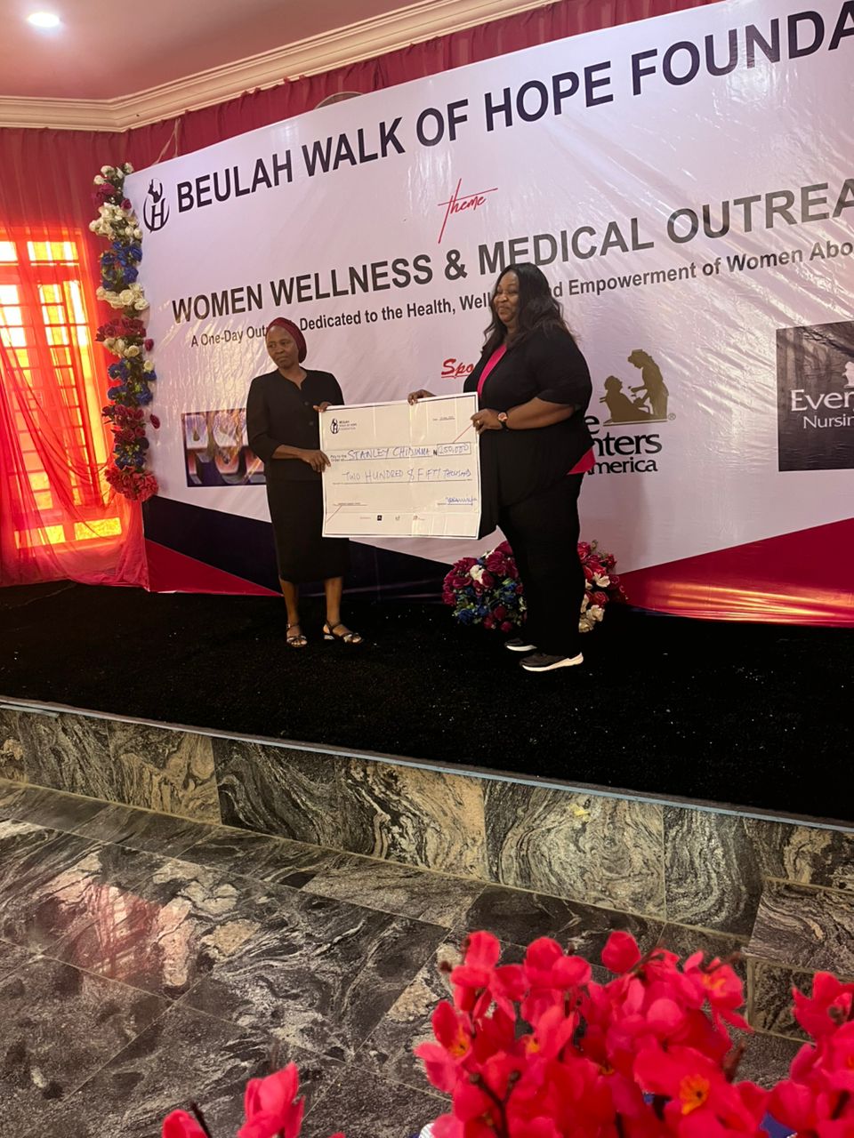 The founder presenting a fertility support grant to a beneficiary