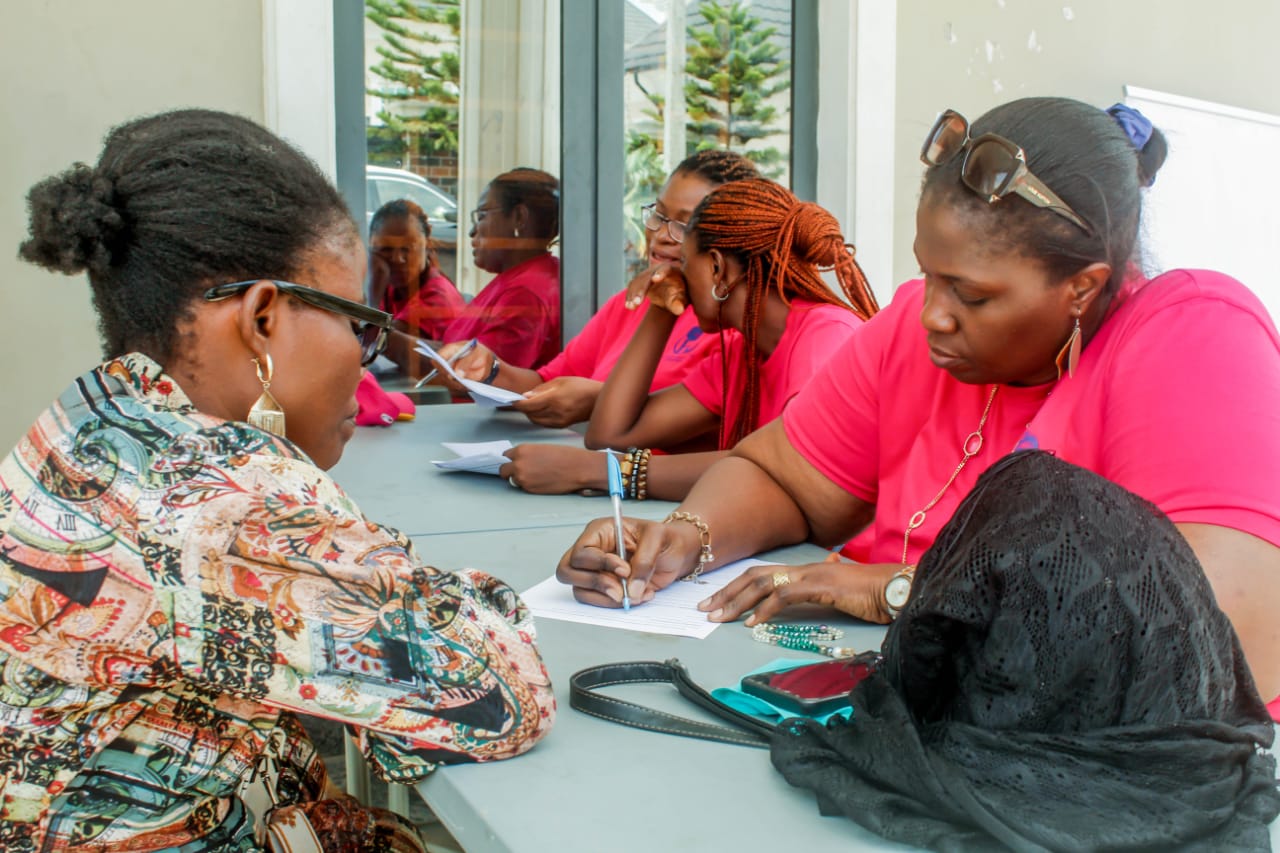 Women being attended to and registering at the event